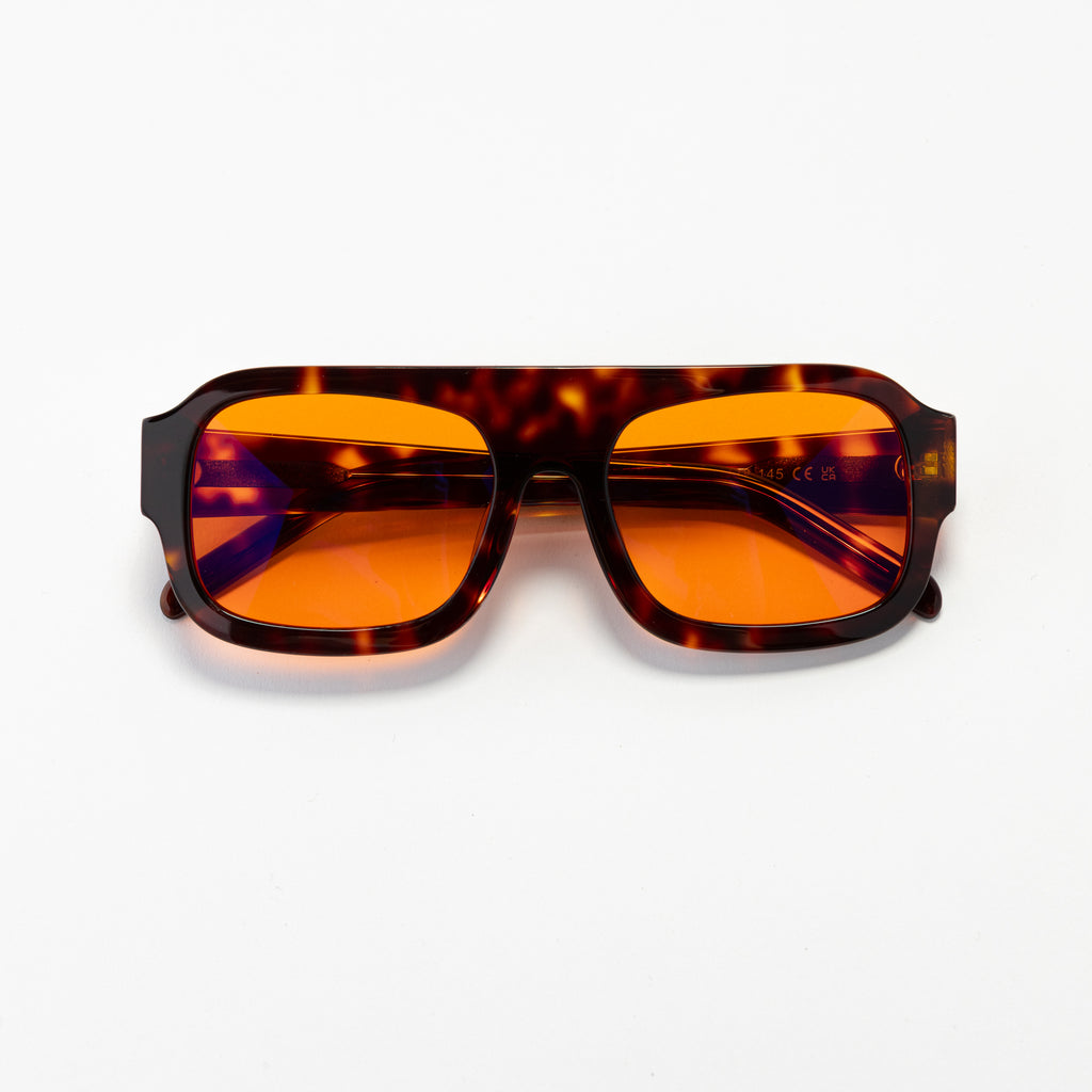 Good In Bed DYLAN blue light blocking glasses in Dark Tortoise with amber OFF DUTY lenses, product flat lay
