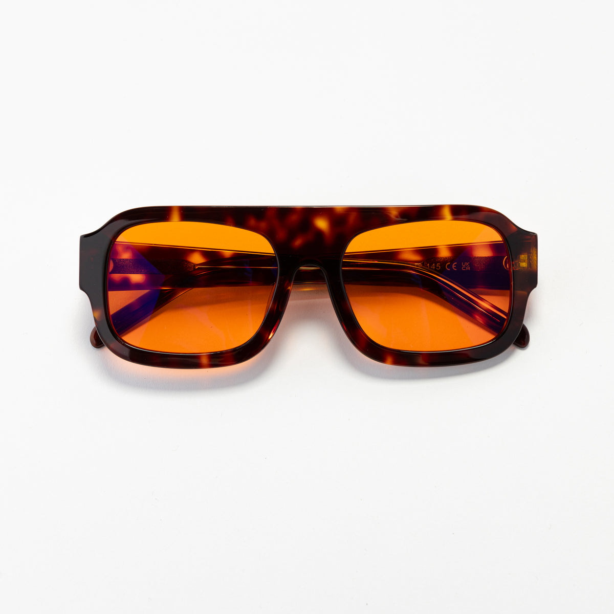Good In Bed DYLAN blue light blocking glasses in Dark Tortoise with amber OFF DUTY lenses, product flat lay
