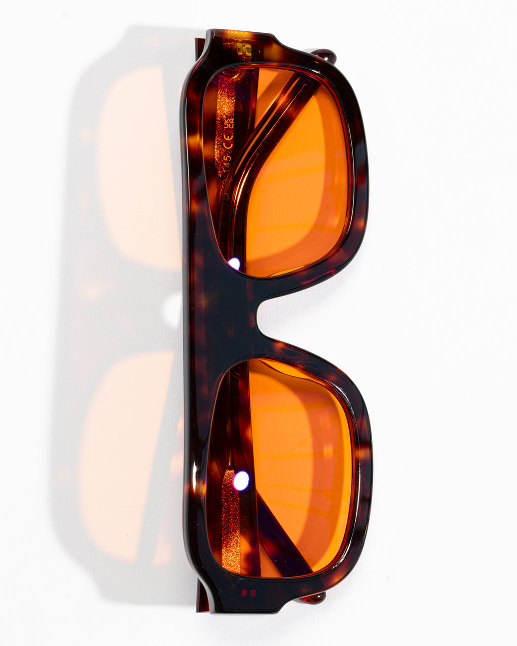 Good In Bed DYLAN blue light blocking glasses in Dark Tortoise with amber lenses, vertical product flat lay
