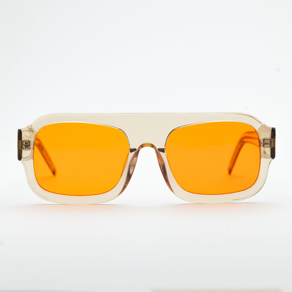 Good In Bed DYLAN blue light blocking glasses in Translucent Honey, front-facing product shot with amber lenses