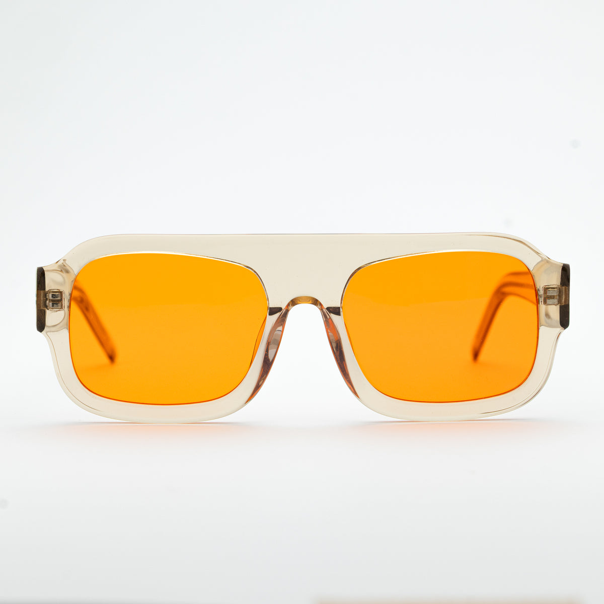 Good In Bed DYLAN blue light blocking glasses in Translucent Honey, front-facing product shot with amber lenses