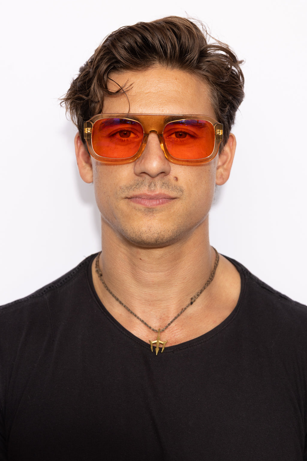 Man wearing Good In Bed DYLAN blue light blocking glasses in Translucent Honey, front-facing lifestyle shot