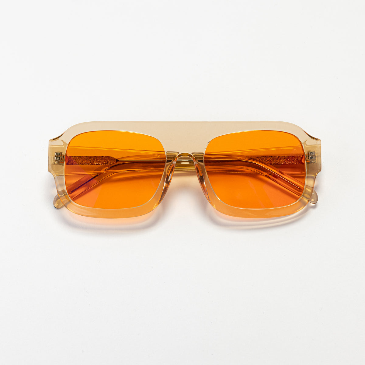 Good In Bed DYLAN blue light blocking glasses in Translucent Honey with amber OFF DUTY lenses, product flat lay