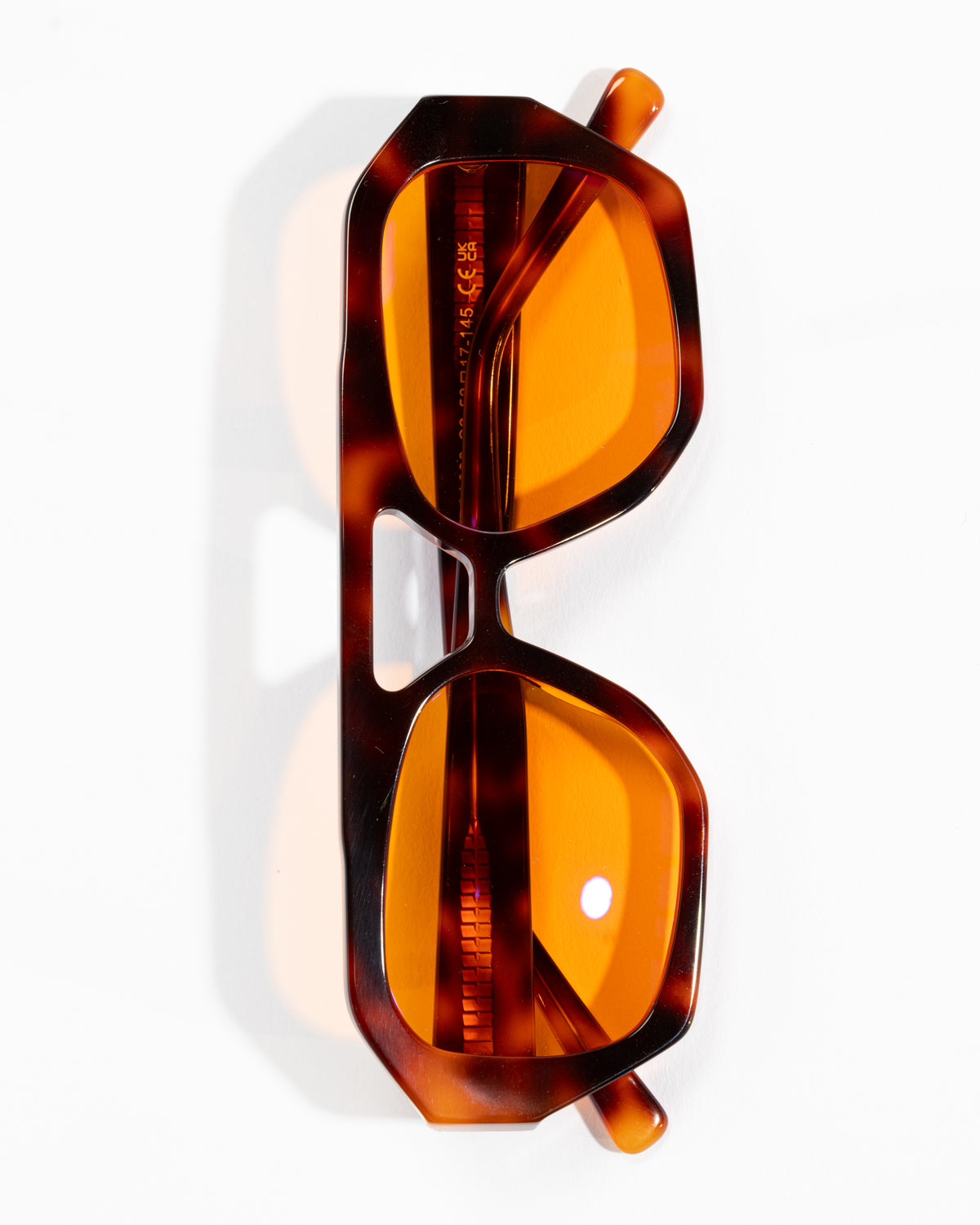 Good In Bed KAI blue light blocking glasses in Dark Tortoise with amber lenses, vertical product flat lay