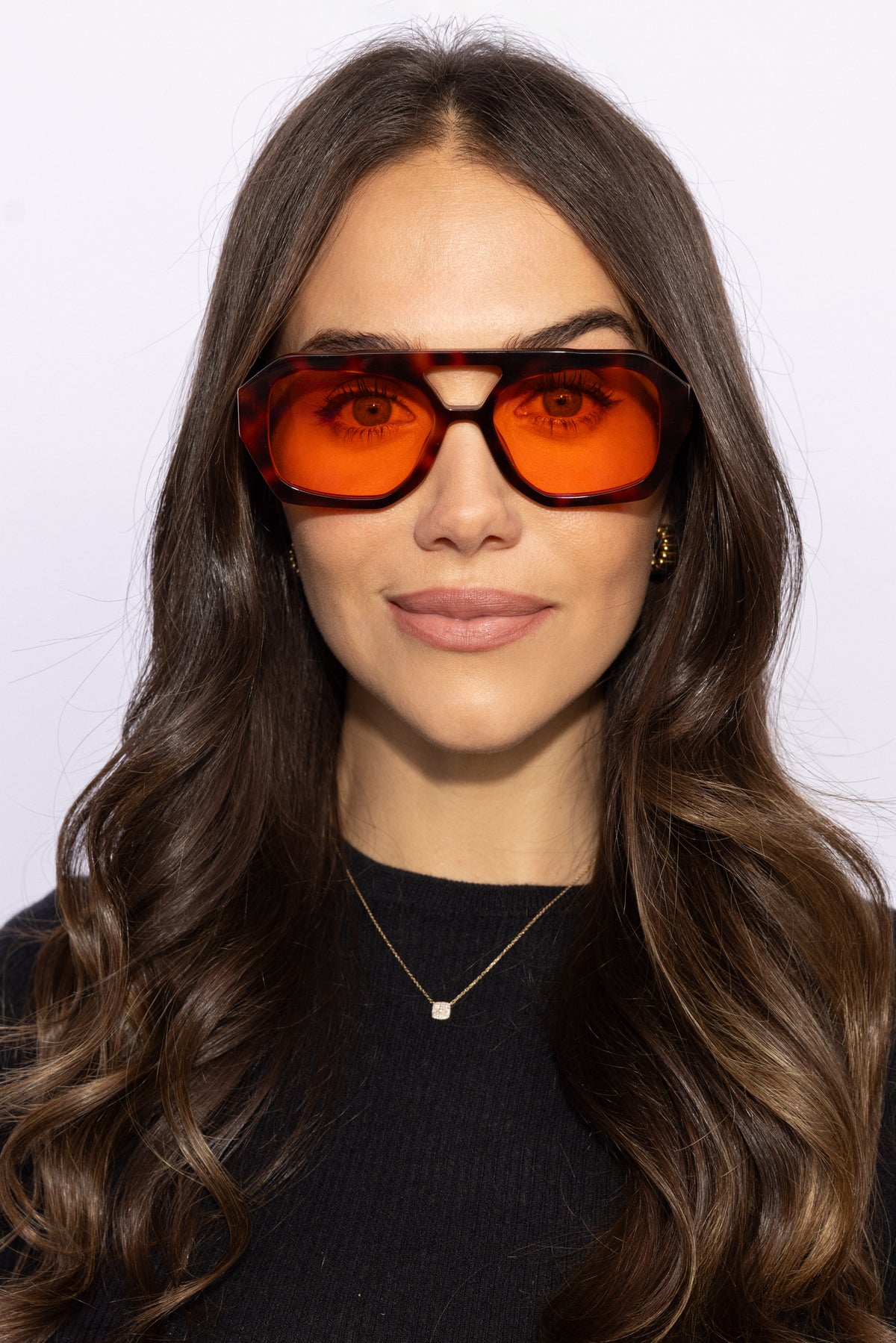 Woman wearing Good In Bed KAI blue light blocking glasses in Dark Tortoise, front-facing lifestyle shot