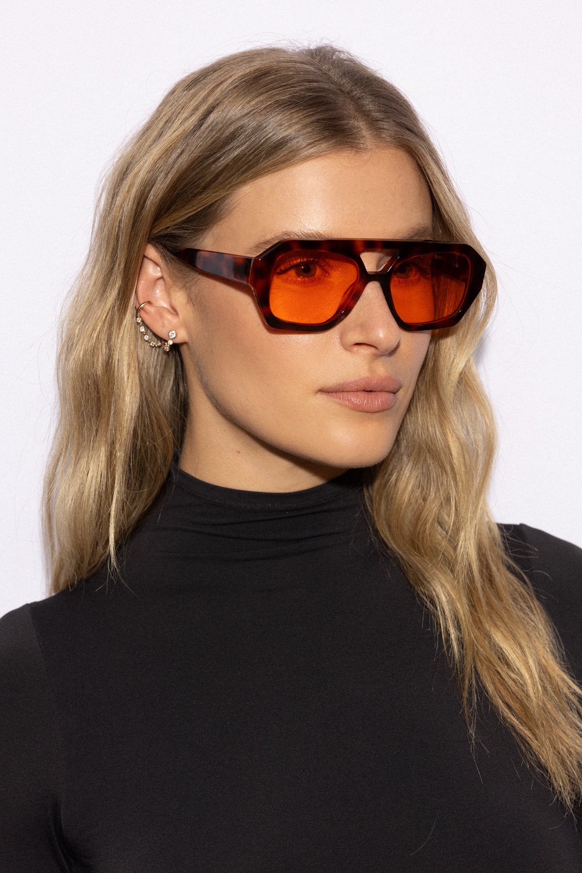 Woman wearing Good In Bed KAI blue light blocking glasses in Dark Tortoise, side profile lifestyle shot
