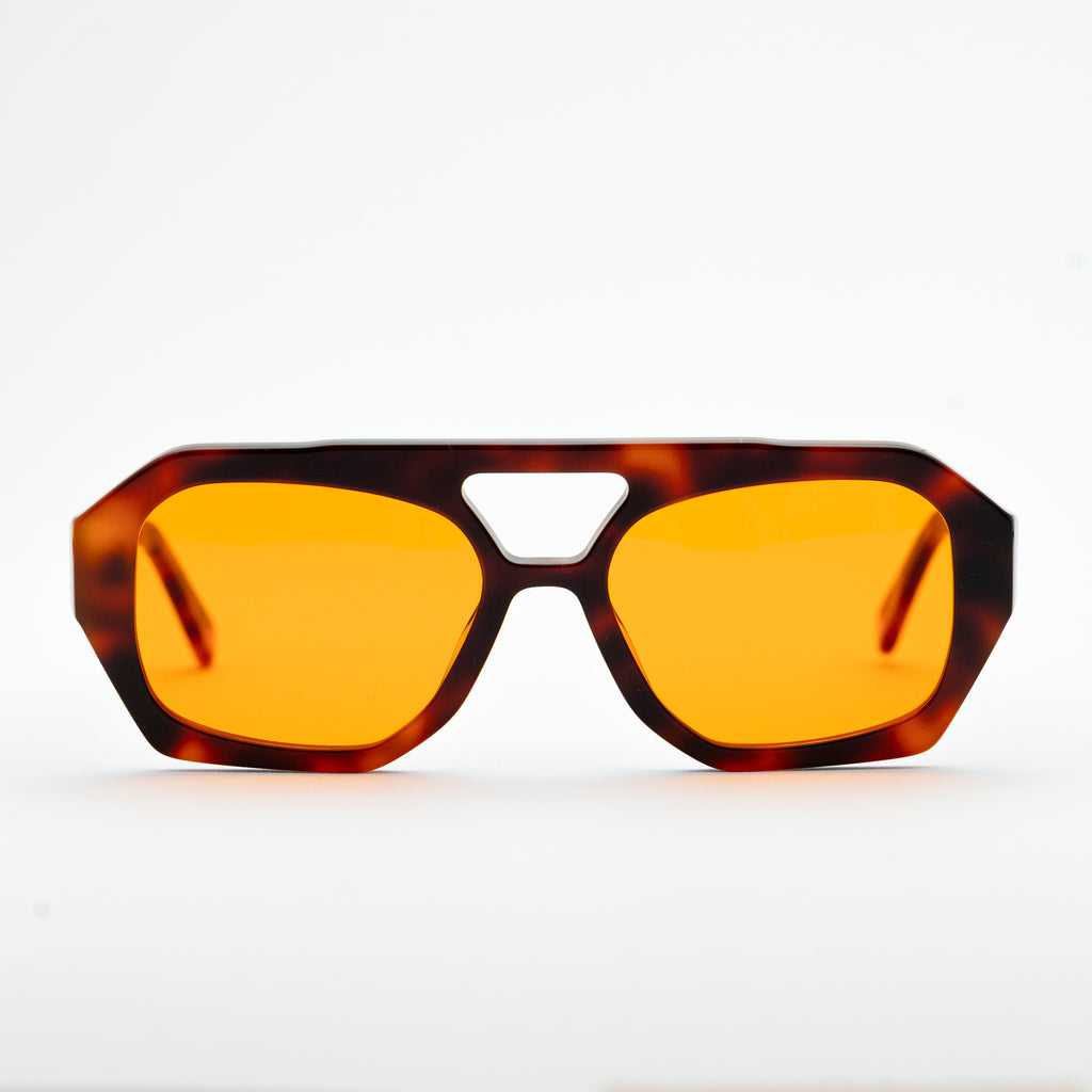 Good In Bed KAI blue light blocking glasses in Dark Tortoise, front-facing product shot with amber lenses