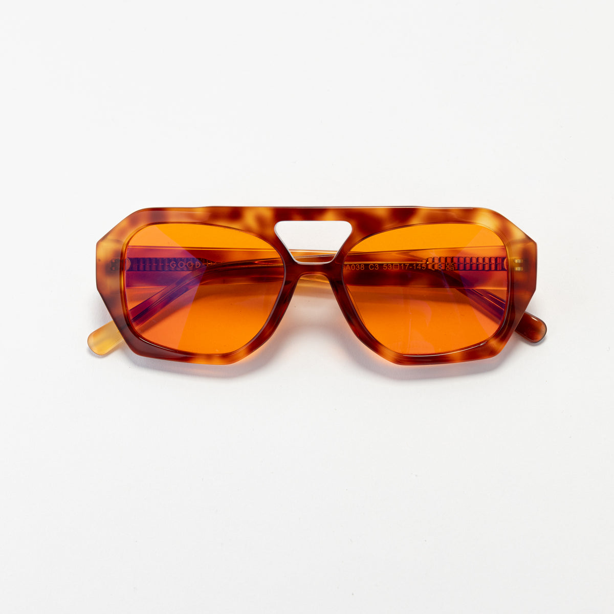 Good In Bed KAI blue light blocking glasses in Light Tortoise with amber OFF DUTY lenses, product flat lay
