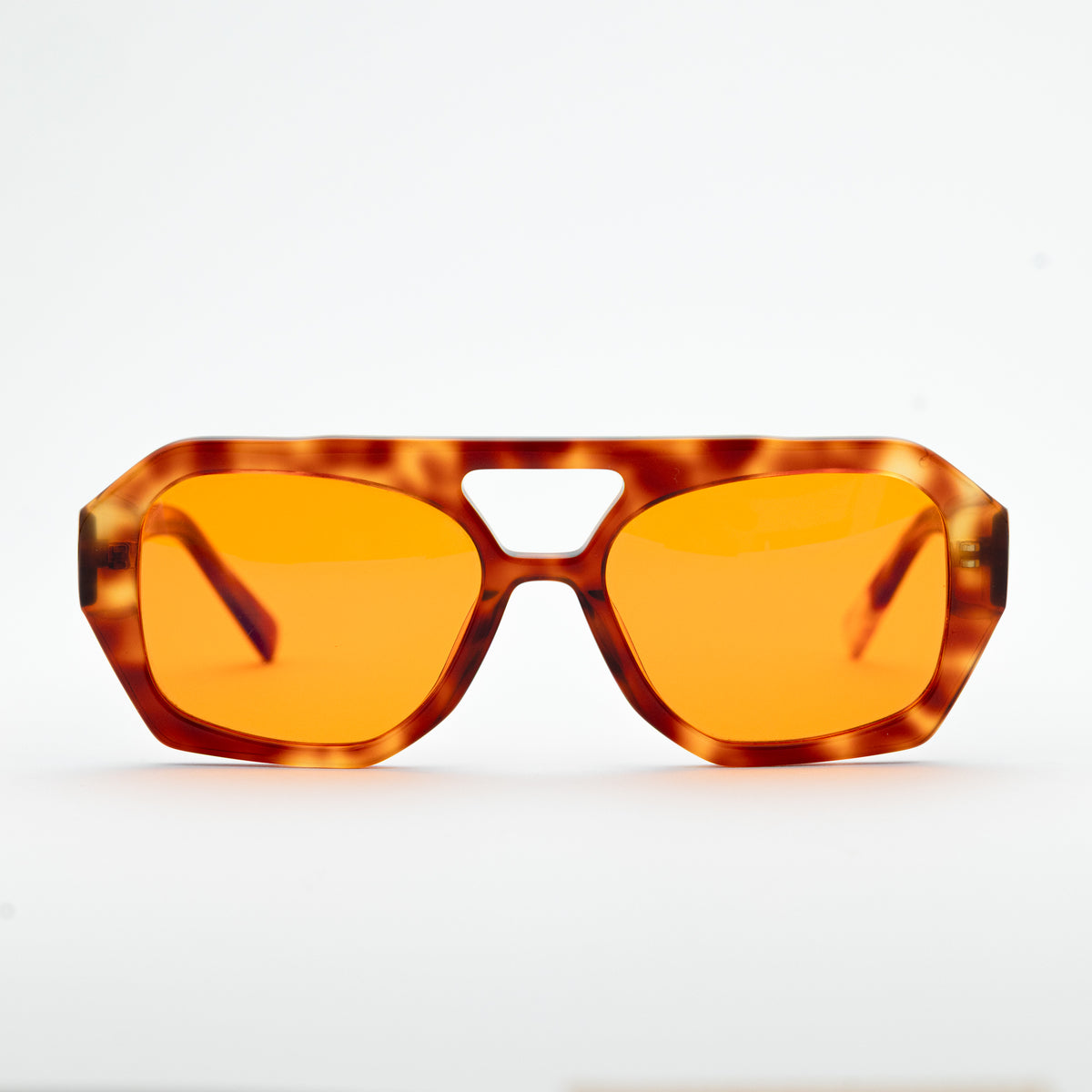 Good In Bed KAI blue light blocking glasses in Light Tortoise, front-facing product shot with amber lenses