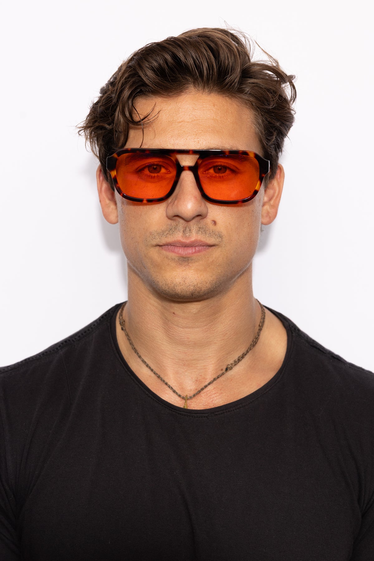 Man wearing Good In Bed RILEY blue light blocking glasses in Dark Tortoise, front-facing lifestyle shot