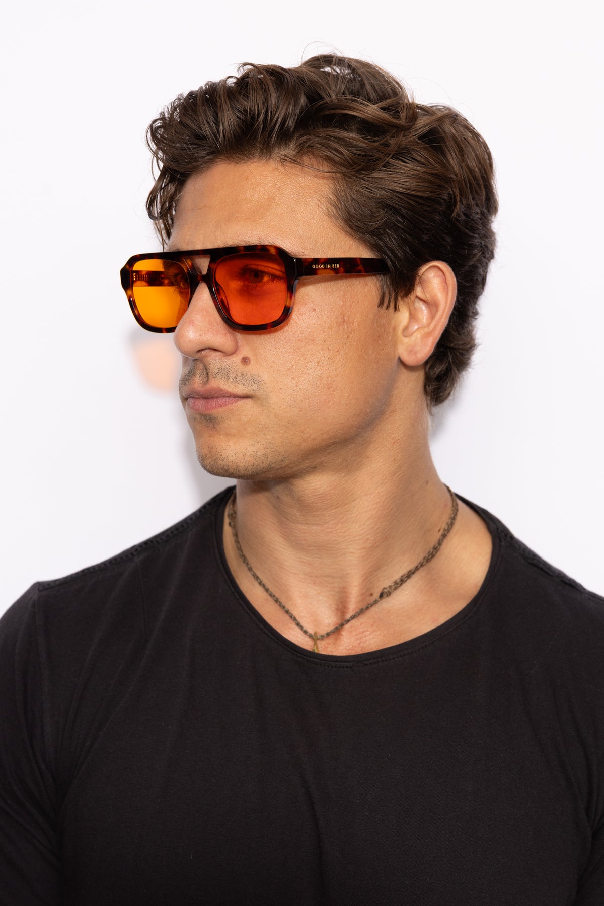 Man wearing Good In Bed RILEY blue light blocking glasses in Dark Tortoise, 3/4 profile lifestyle shot